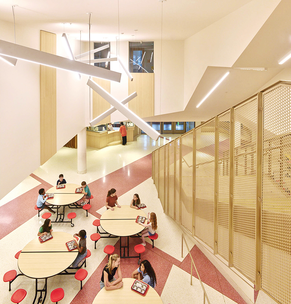Children at tables near staircase